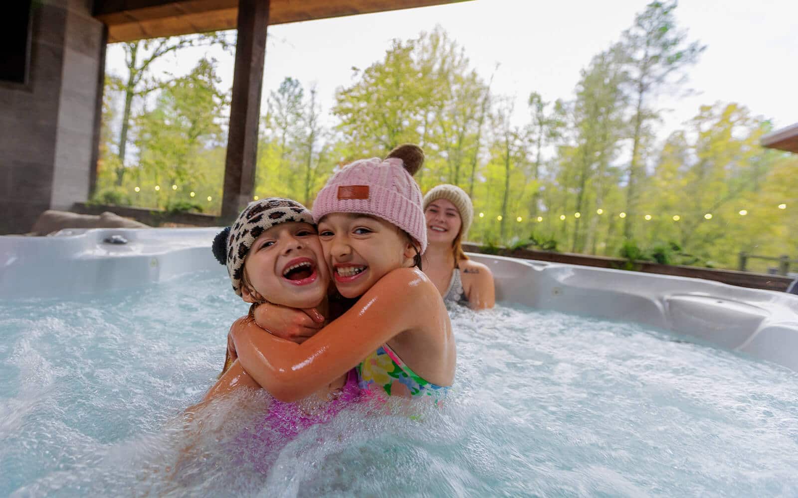 Two young girls in the hot tub at a luxury cabin in Beavers Bend Cabin Country