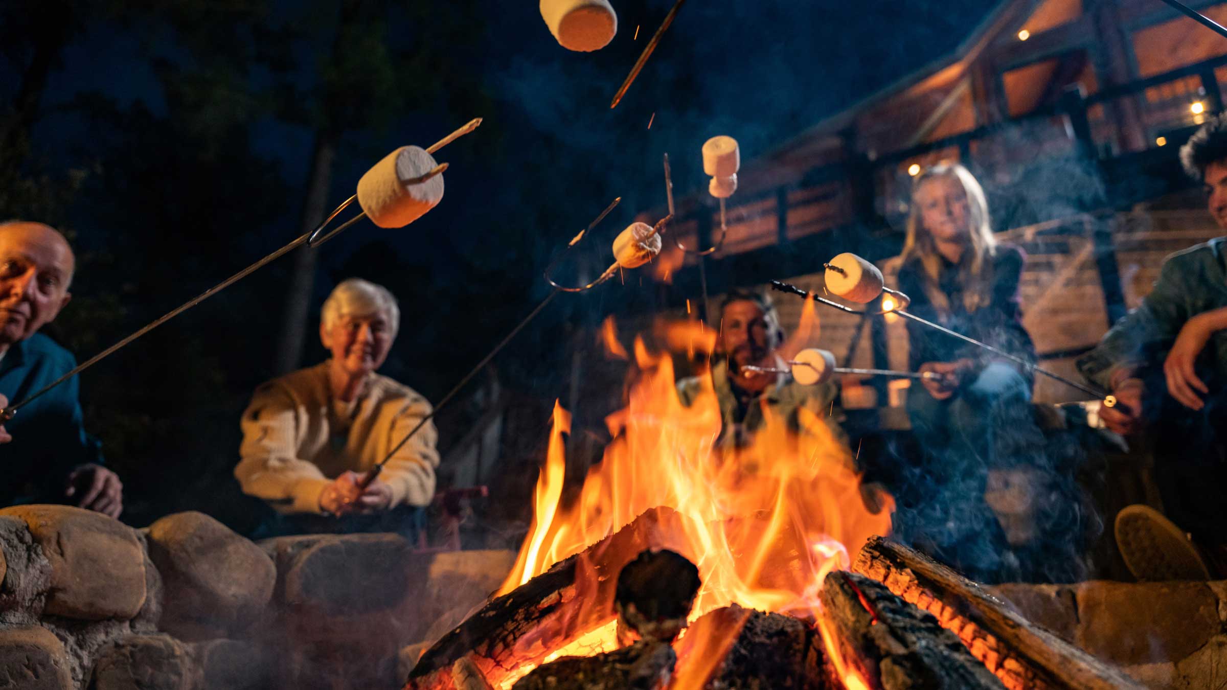 Cooking marshmallows over the campfire behind a luxury cabin in Beavers Bend