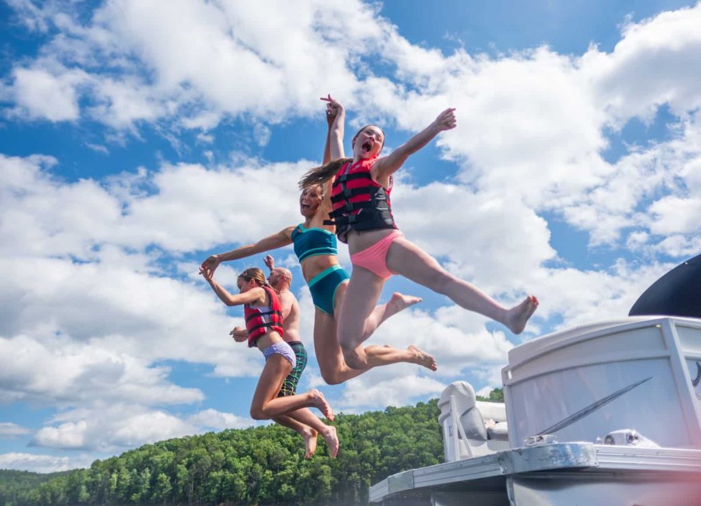 Jumping off the boat into Broken Bow Lake in Beavers Bend State Park