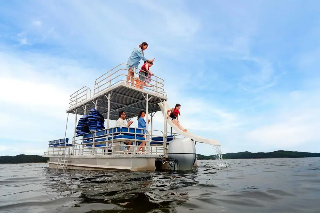 A family enjoys a lake day with a boat rental – including a slide!